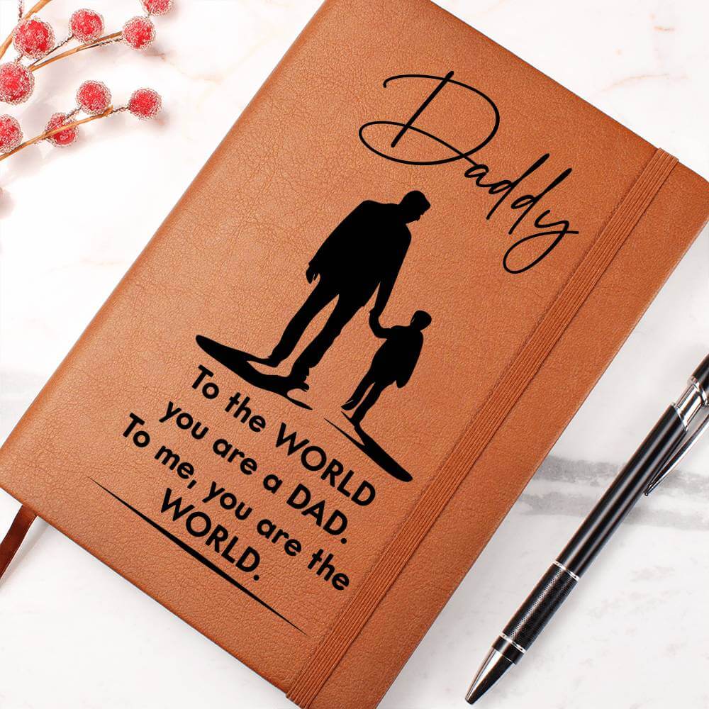 Daddy, to the World you are a Dad - Graphic Leather JournalVenture beyond with the Graphic Leather Journal. Ideal for goal setting and organization, it features a bookmark and elastic closure.Moving Phrases