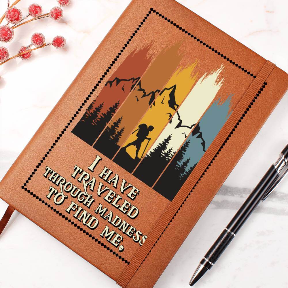 I have traveled through madness - Graphic Leather JournalVenture beyond with the Graphic Leather Journal. Ideal for goal setting and organization, it features a bookmark and elastic closure.Moving Phrases