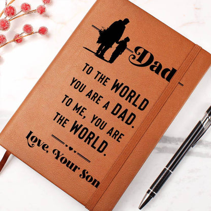 Dad, to the World you are - Graphic Leather JournalVenture beyond with the Graphic Leather Journal. Ideal for goal setting and organization, it features a bookmark and elastic closure.Moving Phrases