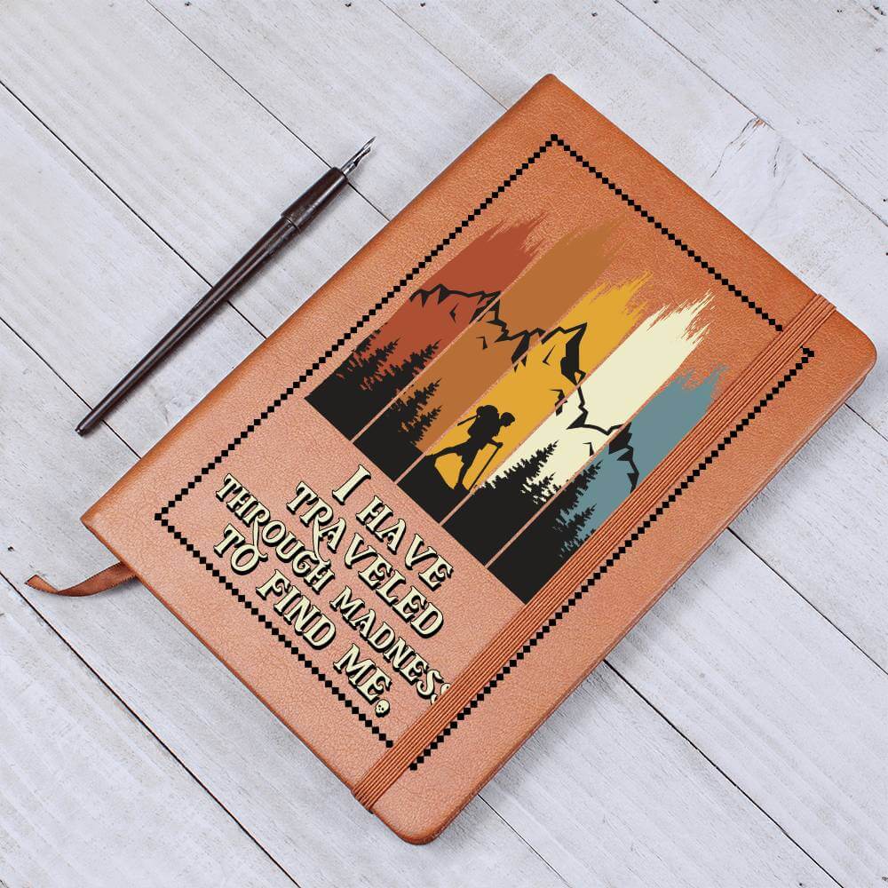 I have traveled through madness - Graphic Leather JournalVenture beyond with the Graphic Leather Journal. Ideal for goal setting and organization, it features a bookmark and elastic closure.Moving Phrases