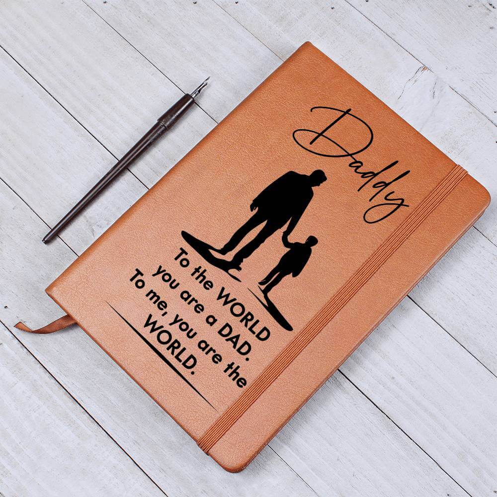 Daddy, to the World you are a Dad - Graphic Leather JournalVenture beyond with the Graphic Leather Journal. Ideal for goal setting and organization, it features a bookmark and elastic closure.Moving Phrases