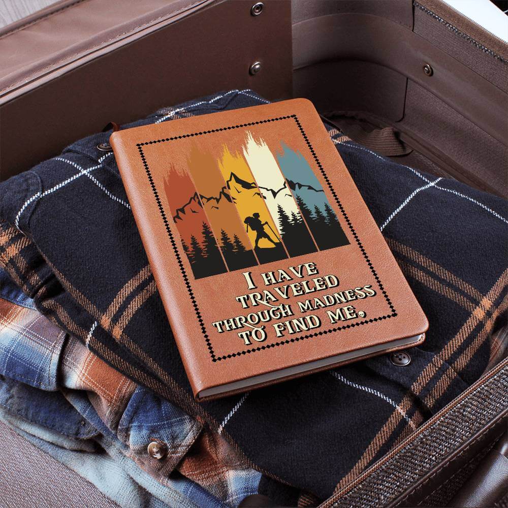 I have traveled through madness - Graphic Leather JournalVenture beyond with the Graphic Leather Journal. Ideal for goal setting and organization, it features a bookmark and elastic closure.Moving Phrases