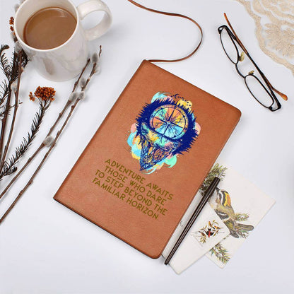 Adventure Awaits - Graphic Leather JournalVenture beyond with the Graphic Leather Journal. Ideal for goal setting and organization, it features a bookmark and elastic closure.Moving Phrases