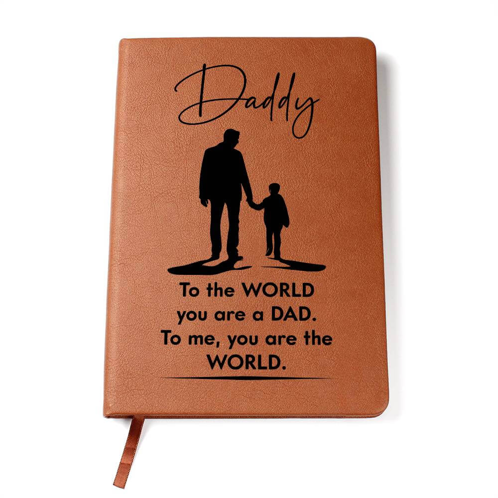 Daddy, to the World you are a Dad - Graphic Leather JournalVenture beyond with the Graphic Leather Journal. Ideal for goal setting and organization, it features a bookmark and elastic closure.Moving Phrases