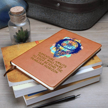 Adventure Awaits - Graphic Leather JournalVenture beyond with the Graphic Leather Journal. Ideal for goal setting and organization, it features a bookmark and elastic closure.Moving Phrases