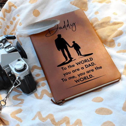 Daddy, to the World you are a Dad - Graphic Leather JournalVenture beyond with the Graphic Leather Journal. Ideal for goal setting and organization, it features a bookmark and elastic closure.Moving Phrases