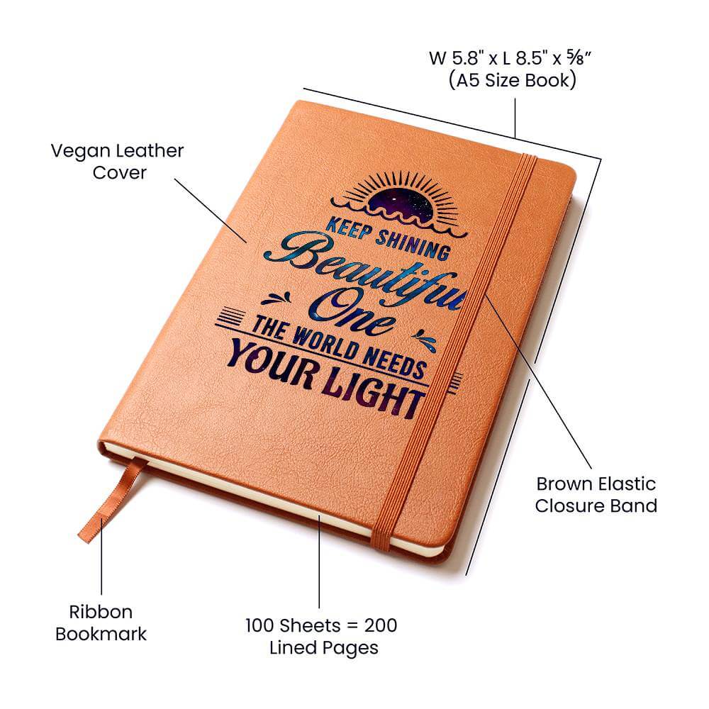 Keep Shining Beautiful One - Graphic Leather JournalVenture beyond with the Graphic Leather Journal. Ideal for goal setting and organization, it features a bookmark and elastic closure.Moving Phrases