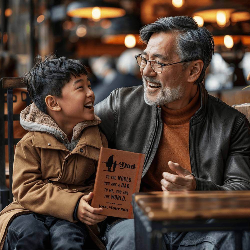 Dad, to the World you are - Graphic Leather JournalVenture beyond with the Graphic Leather Journal. Ideal for goal setting and organization, it features a bookmark and elastic closure.Moving Phrases