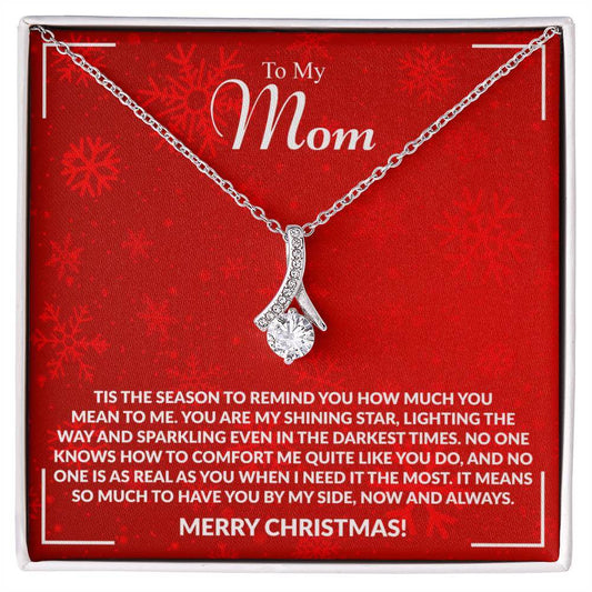 Elegant necklace on red card with heartfelt Christmas message to Mom, symbolizing appreciation and love.