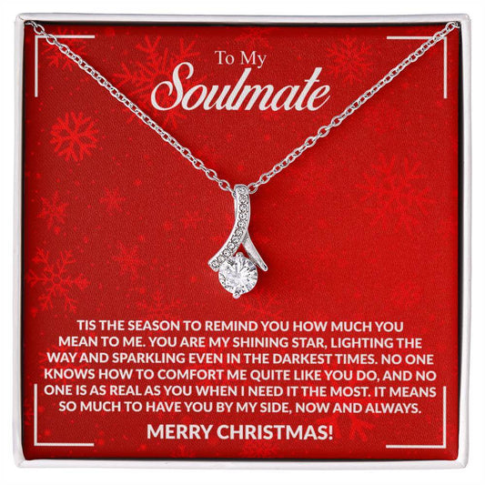 Romantic necklace gift for soulmate with touching Christmas message card saying "You are my shining star" on red festive background.