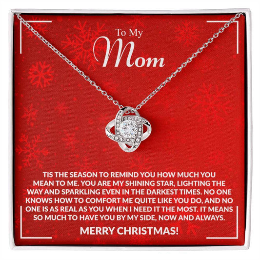 Necklace gift for mom with heartfelt Christmas message on a red card.