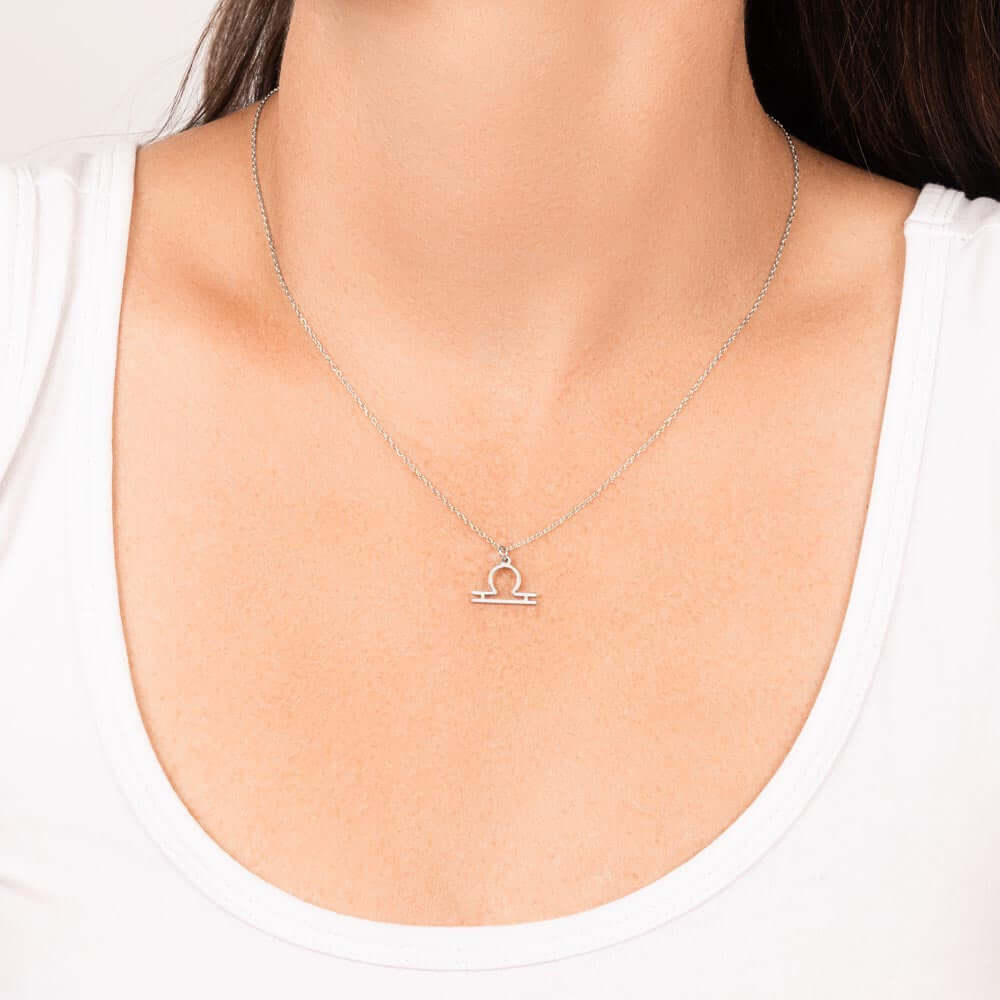 Libra Zodiac Symbol NecklaceImagine her smile when you give her this Zodiac Symbol Necklace. Handcrafted with care, this piece is made from durable stainless steel and optionally dipped in 18k yellow gold and features her unique astrological sign. This wo