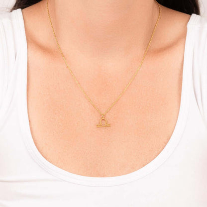 Libra Zodiac Symbol NecklaceImagine her smile when you give her this Zodiac Symbol Necklace. Handcrafted with care, this piece is made from durable stainless steel and optionally dipped in 18k yellow gold and features her unique astrological sign. This wo