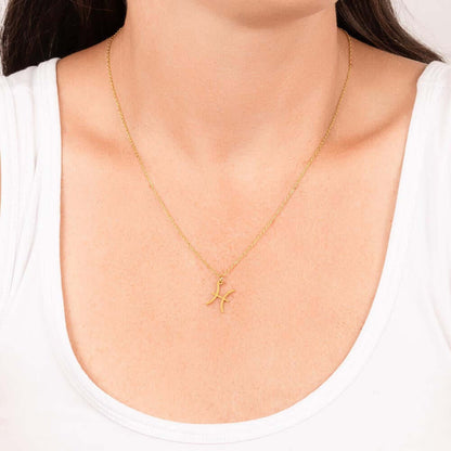 Pisces Zodiac Symbol NecklaceImagine her smile when you give her this Zodiac Symbol Necklace. Handcrafted with care, this piece is made from durable stainless steel and optionally dipped in 18k yellow gold and features her unique astrological sign. This w