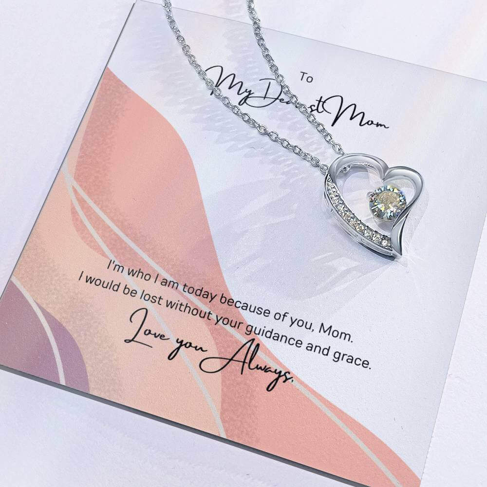 To My Dearest Mom, I am who I am - Love Knot Necklace"Mom, your guidance made me who I am. The Forever Love Necklace with a 6.5mm CZ crystal in a heart pendant is a symbol of my love."Moving Phrases