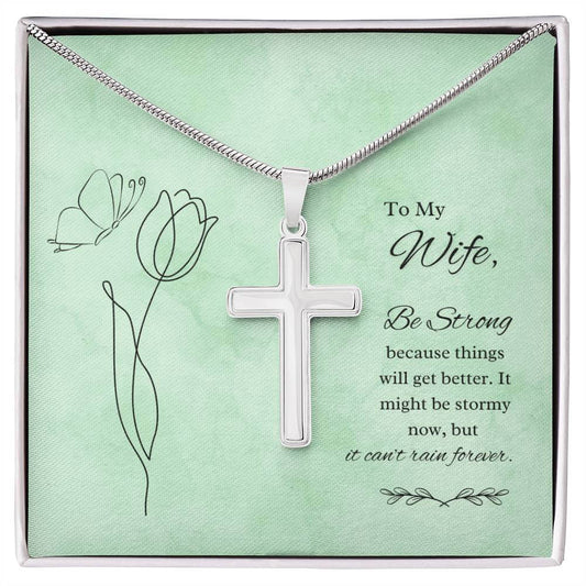 Stainless steel cross necklace with message card saying "To My Wife, Be Strong" on a green background, gift for loved ones.