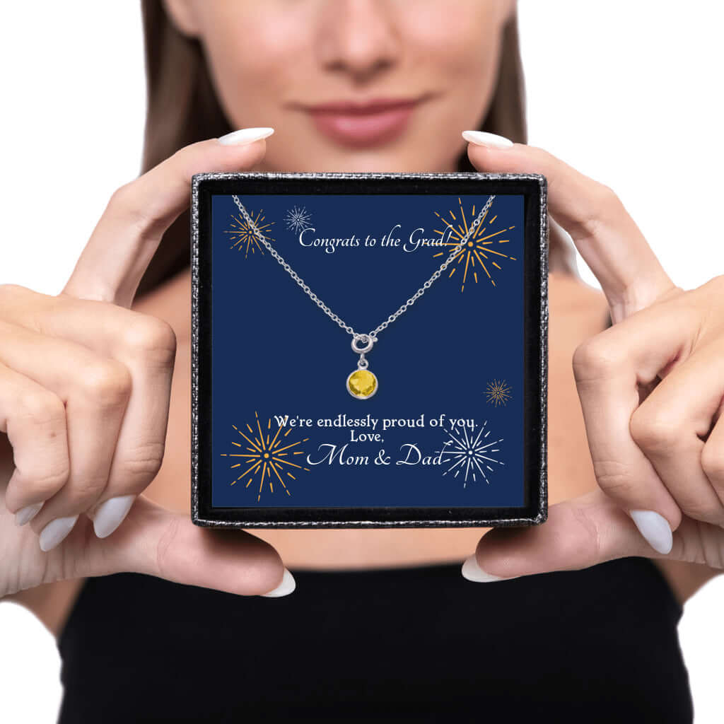 Congrats to the Grad - Birthstone NecklaceA minimalist birthstone necklace that incorporates the color of each birth month from Mom and Dad for graduation. Perfect gift for the perfect event.Moving Phrases